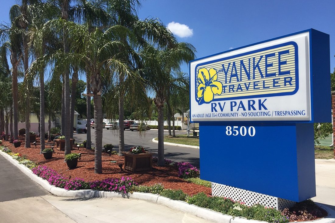 Yankee Traveler RV Park in Florida — a welcoming sign with palm trees