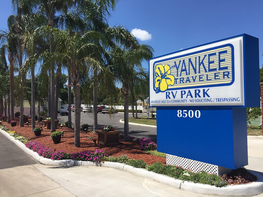 Yankee Traveler RV Park in Florida — a welcoming sign with palm trees