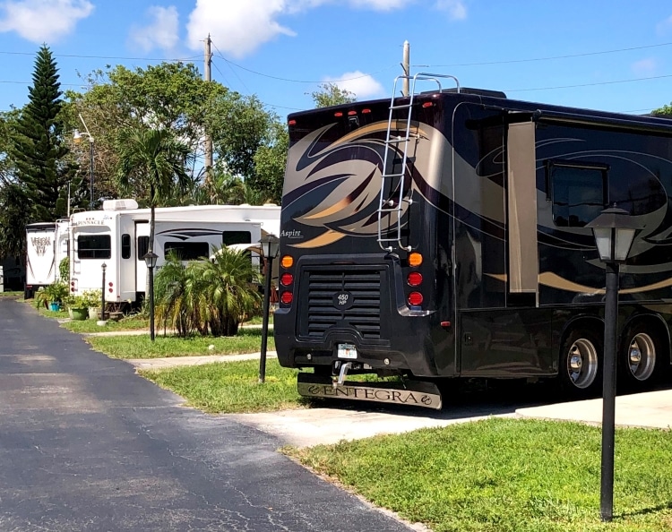 Black motorhome in camp with elegant black streetlights