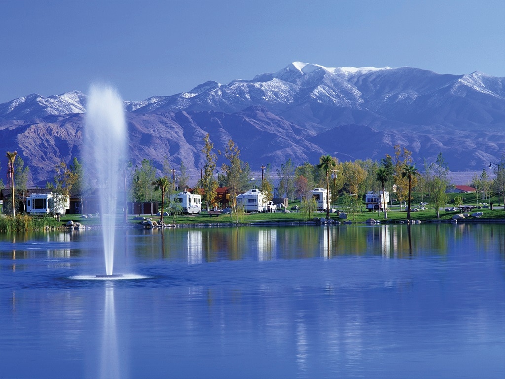 pahrump nevada fall getaway — a row of RVs on a glimmering lakeshore.