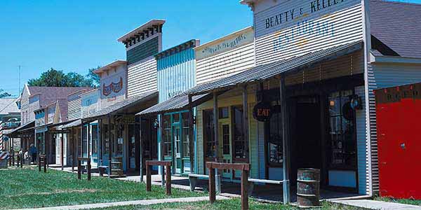 A street scene with Old West style store facades.
