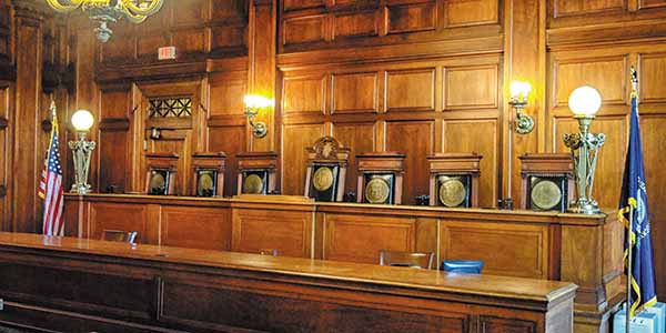 The Kentucky Supreme Courtroom with wood paneling and flags