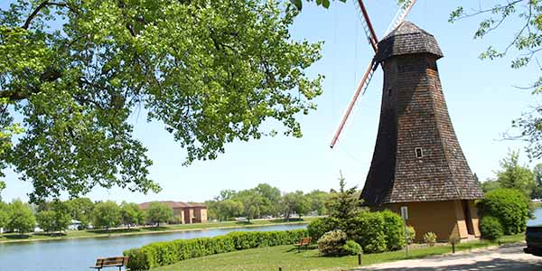 A large windmill next to the river