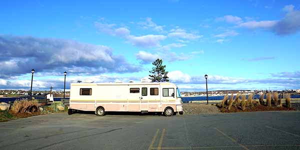 An RV parked in an empty parking lot