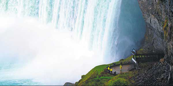 Spectators gather at on the river bank at the foot of the Niagara Falls.
