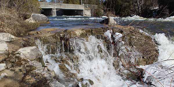 A stream with a bridge in the back