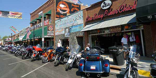 Motorcycles line the curb on a street lined with gin joints, honkytonks, dive bars and greasy spoons.