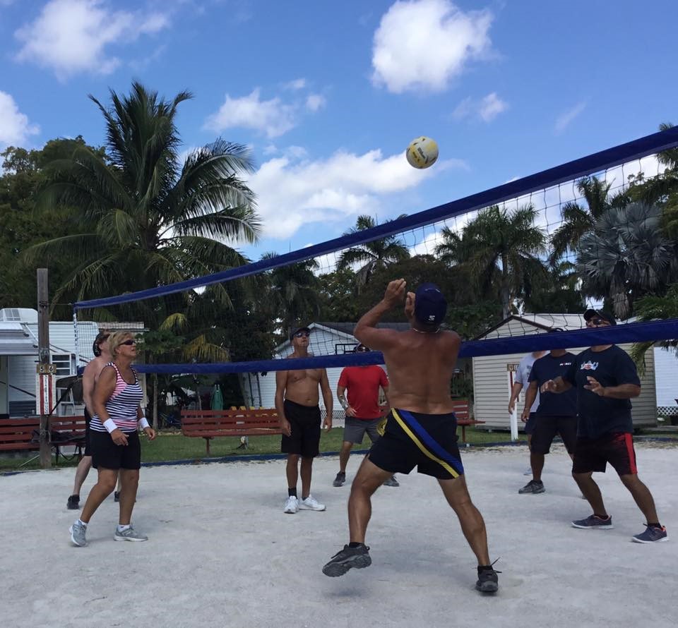 Boardwalk RV Resort — Gateway to the Keys — folks playing vollyball on a sandy court