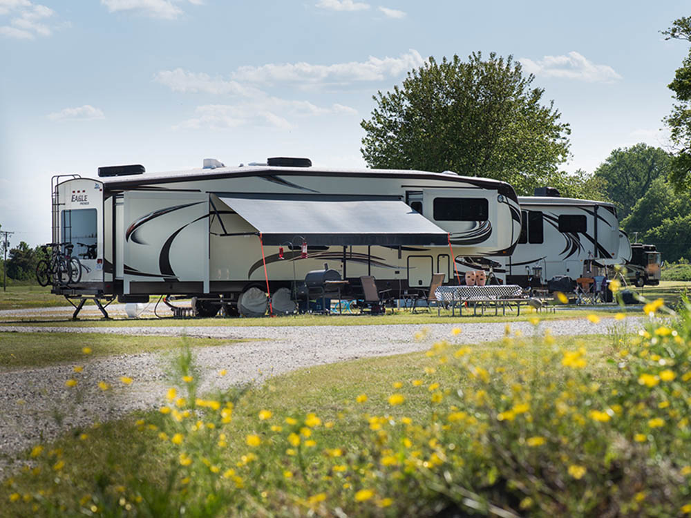 A fifth-wheel trailer parked in an ample site.