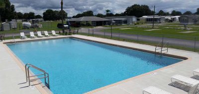 A sprawling rectangular pool amid an RV resort.