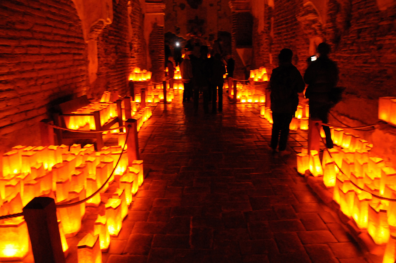 Luminarias line the walls of a Mission breezeway. 