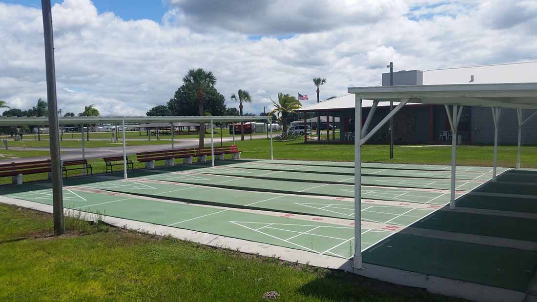 Shuffleboard courts surrounded by lush lawns.