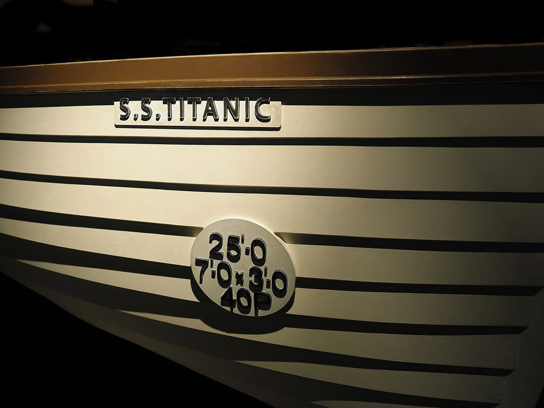 A replica of a titanic lifeboat in low light.<