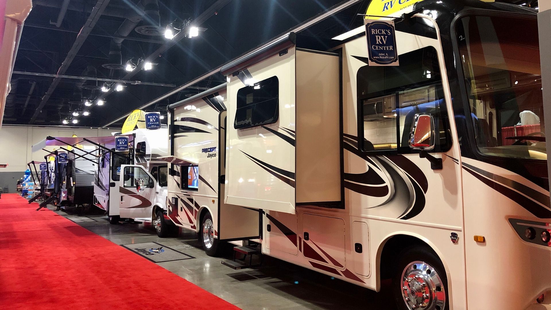 RVs lined in a row at an RV show.