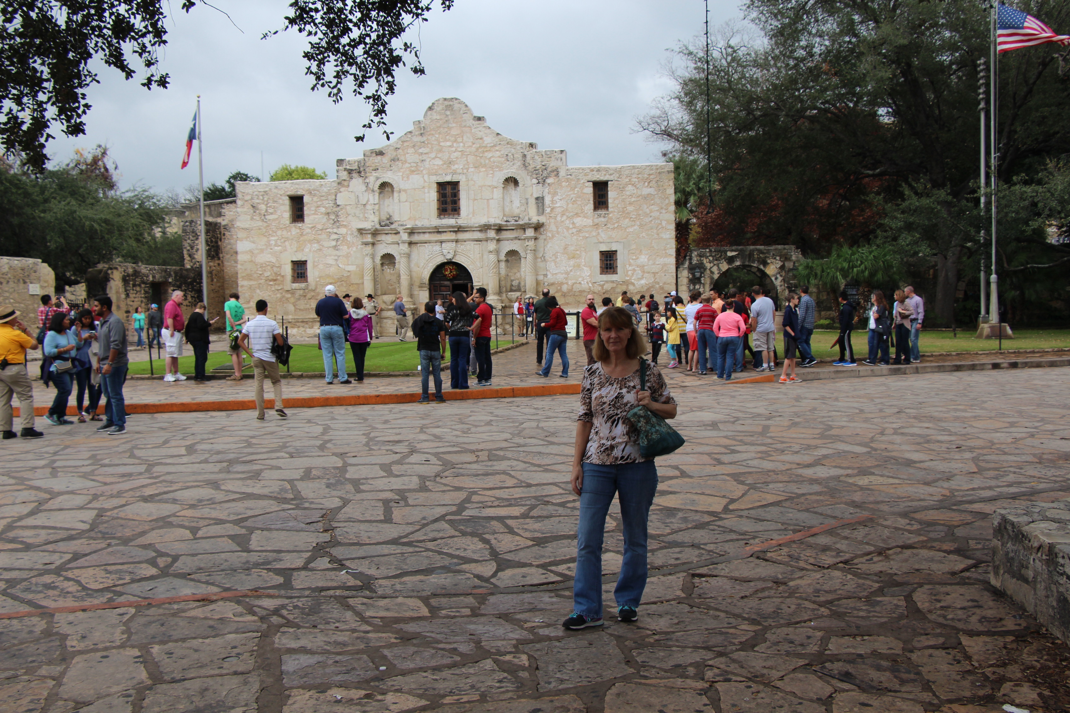 A woman stands near the Alamo in Texas