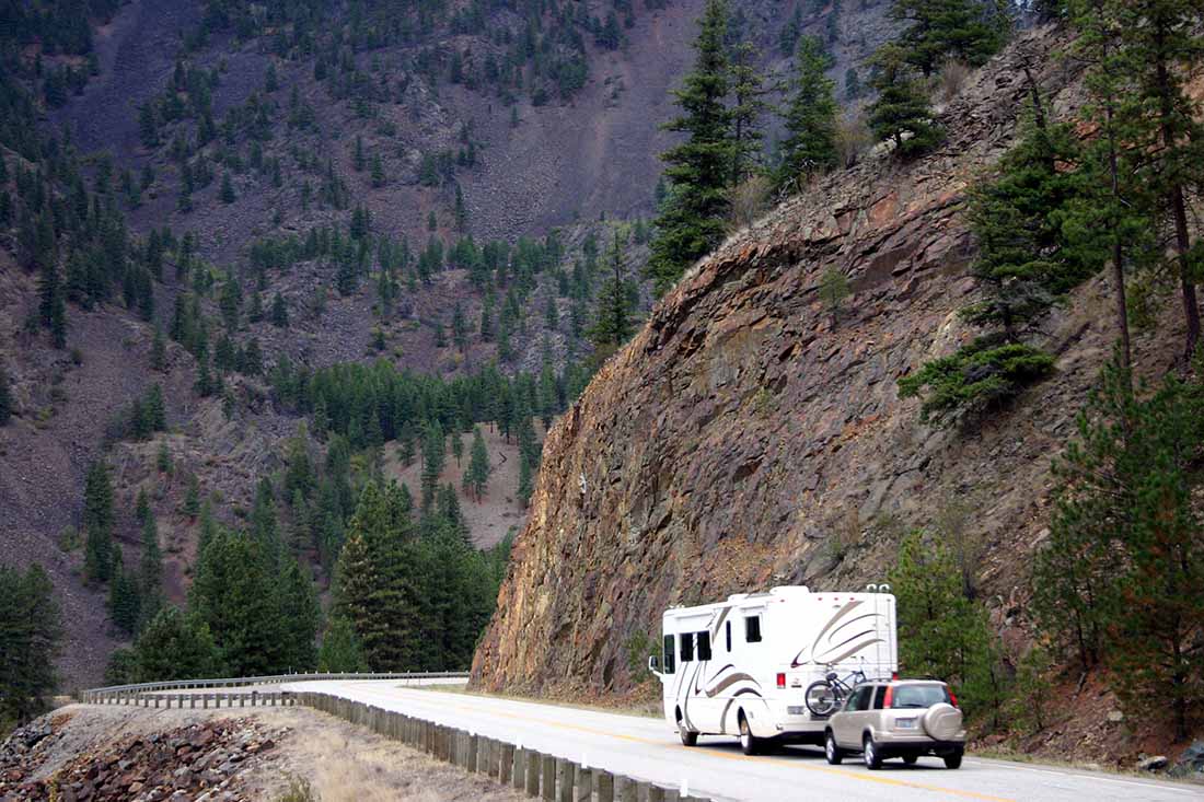 motorhome pulling small suv on a Montana Mountainside