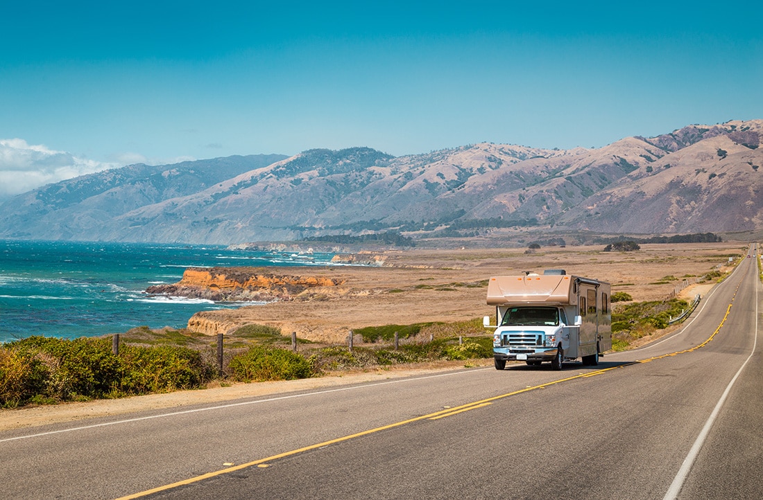 An RV drives along a Coastline