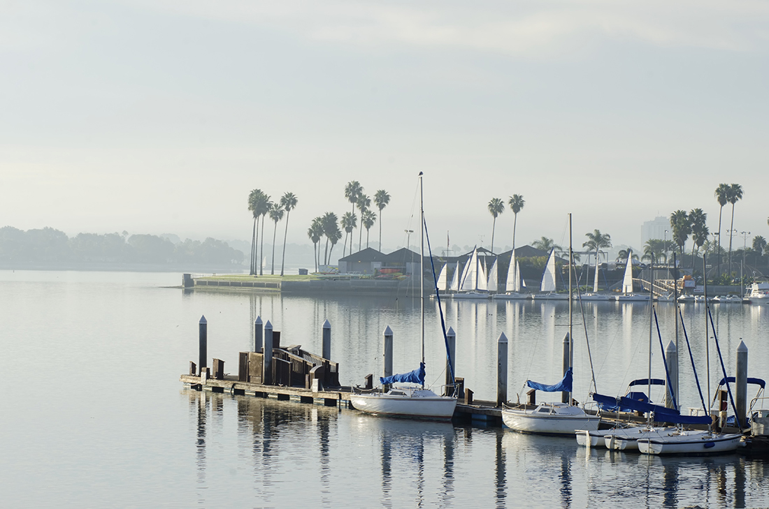 Boats moored to docks on a hazy morning