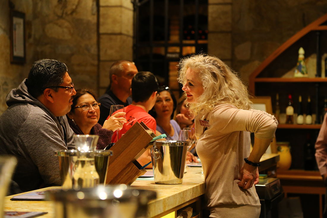 Napa Winery A wine server talks with customers in a Napa winery.