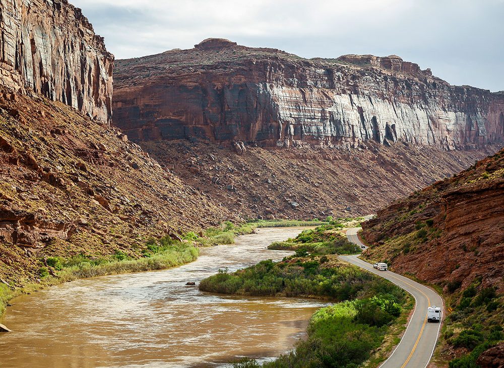 A river runs through a rugged canyon floor.