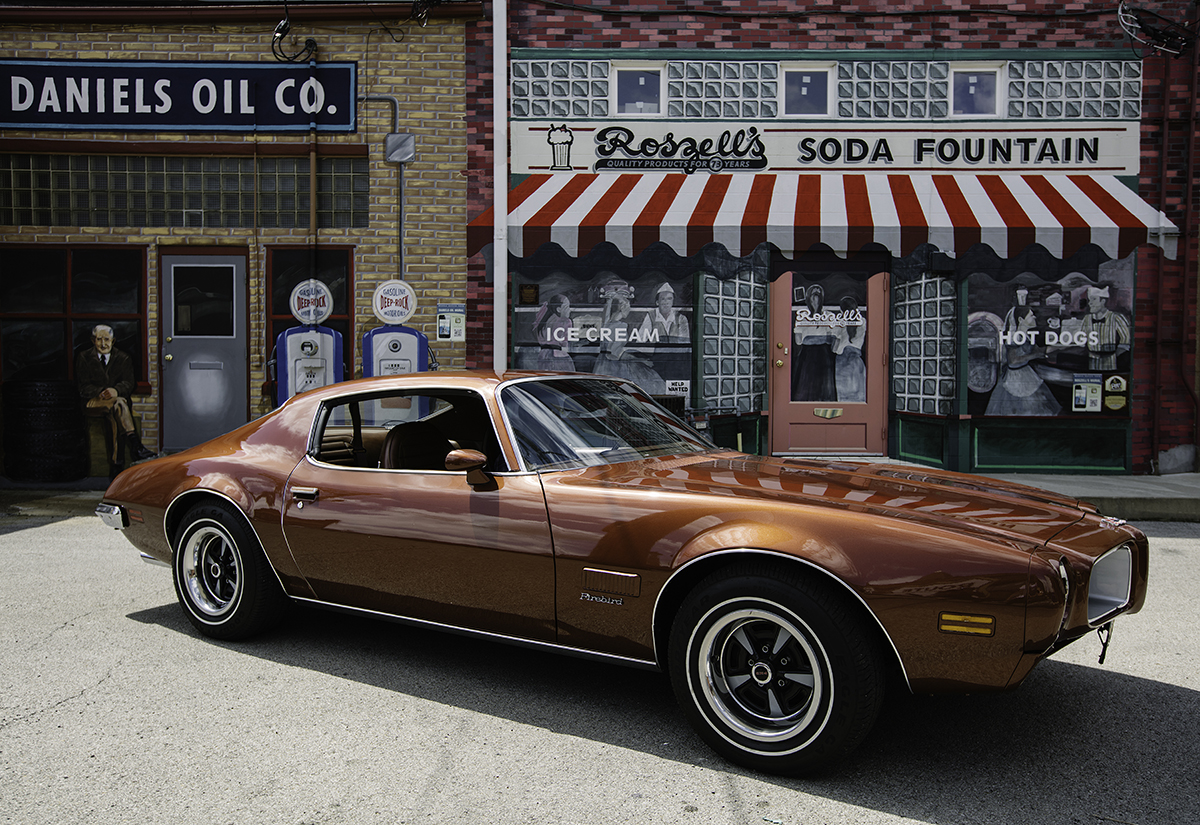 Pontiac Illinois A rust-colored sedan infront of a mural.