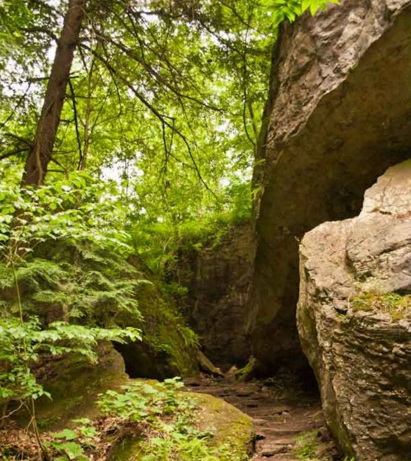 A trail wends between two big boulders