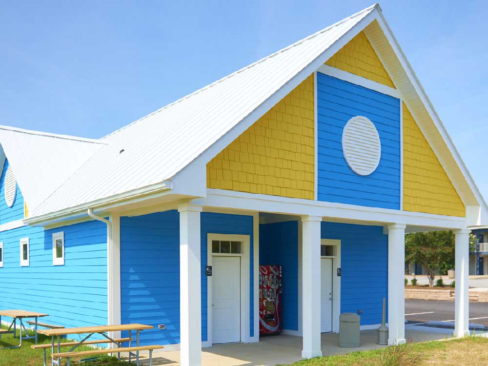 Colorfully painted a-frame restroom facilities.