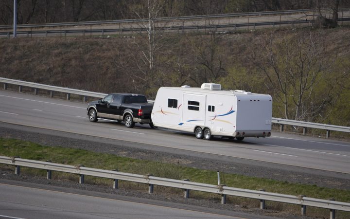 Camper Being Towed by Pickup Truck on the Highway