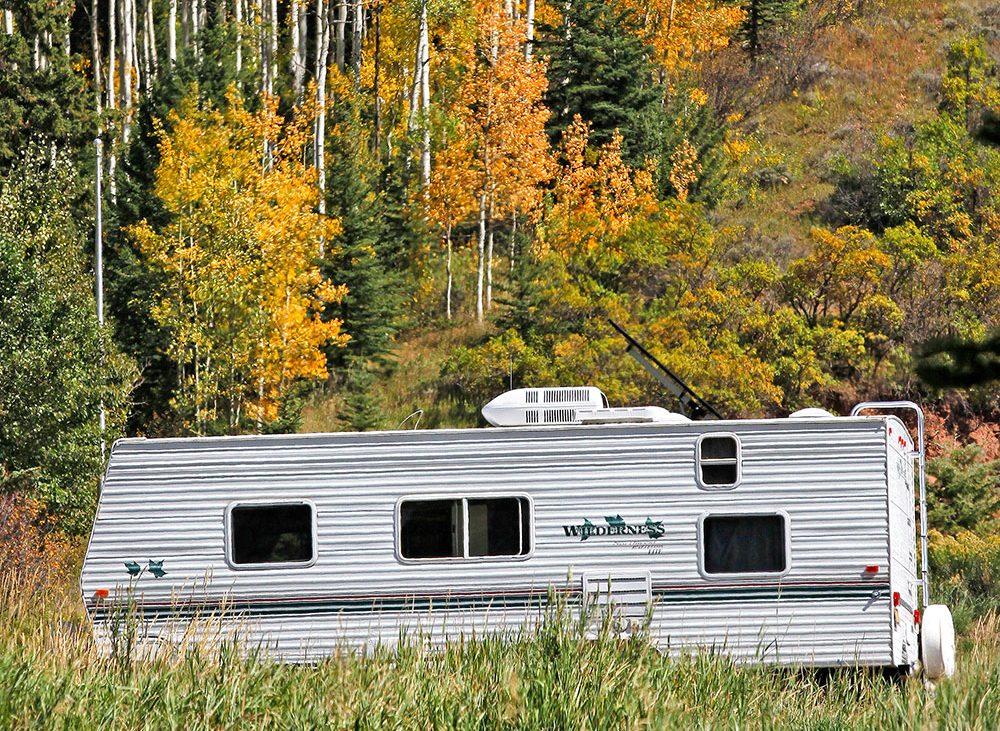 Trailer against a forest backdrop.