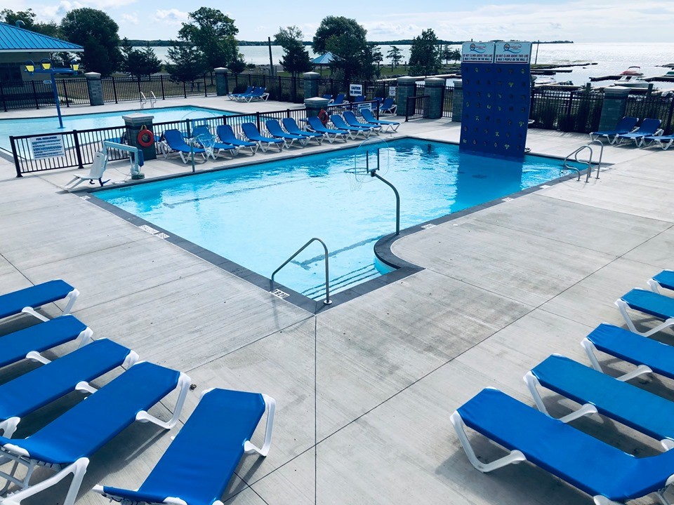 Deck chairs arrayed around a pool