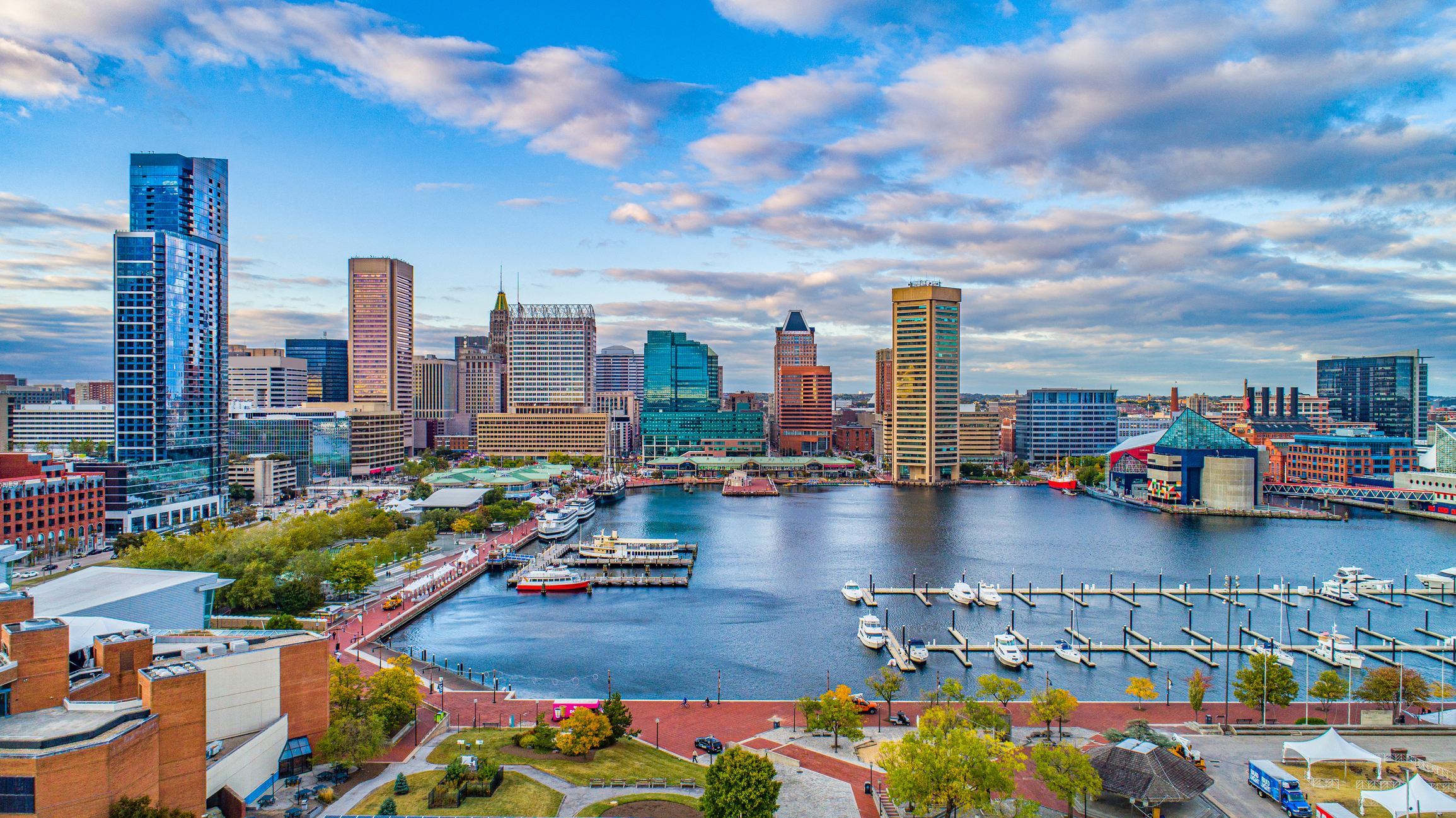 Bustling harbor under towering skyscrapers.