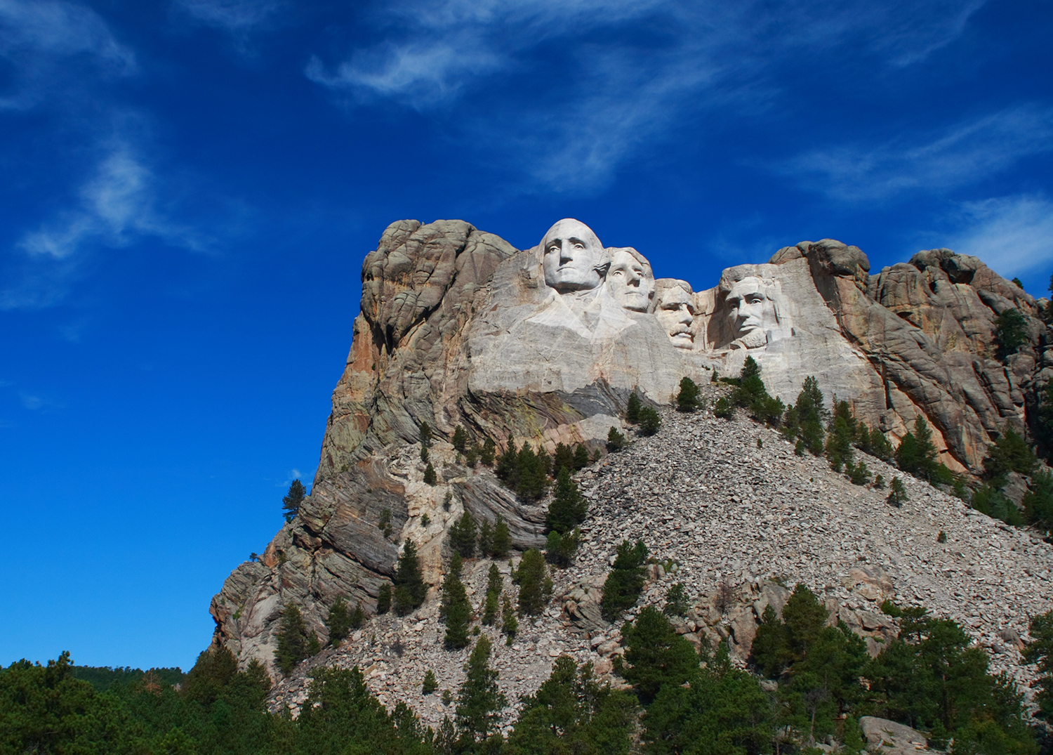 Four presidents' face carved into the face of a mountain.