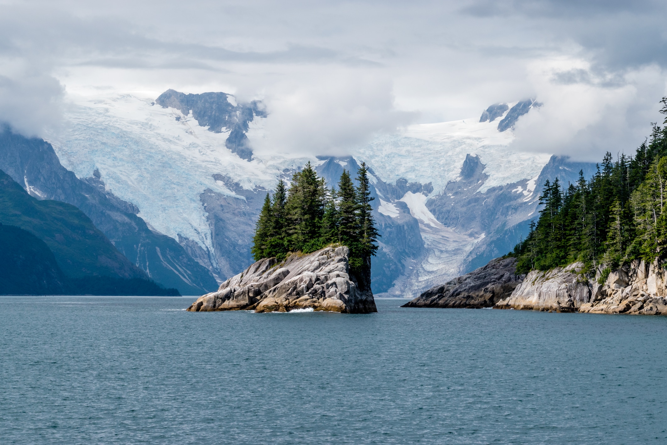 A small island framed by huge glaciers.