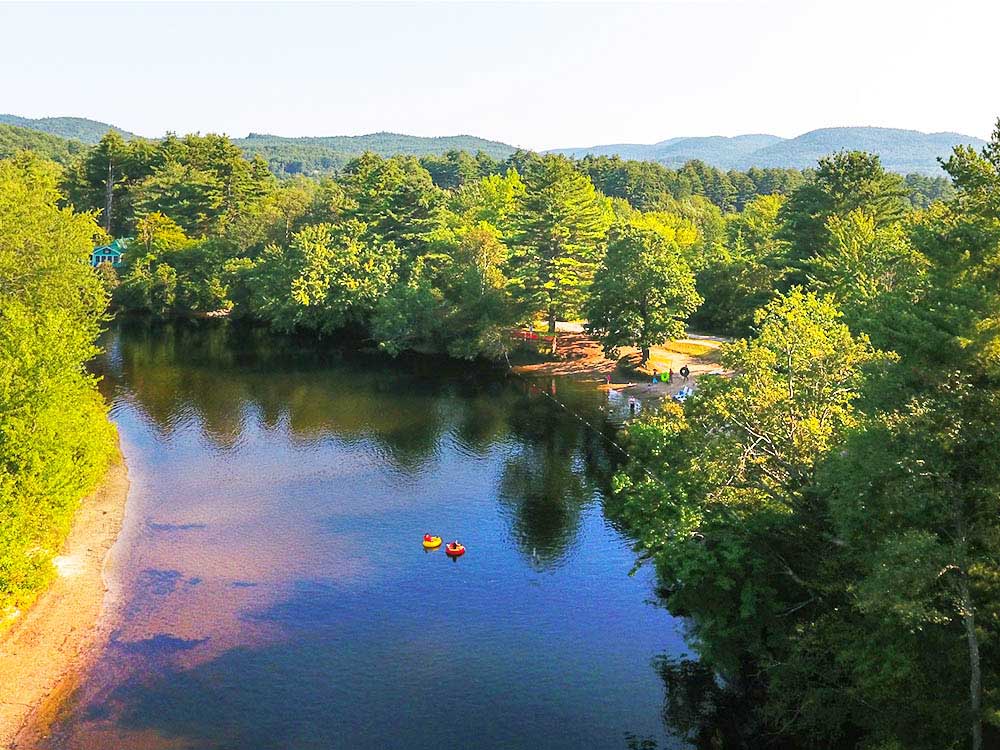 A pair of inner tubes float on a river.