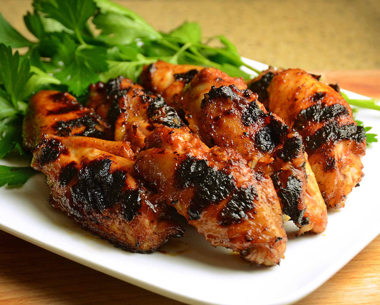 Grilled chicken stacked neatly with greens.