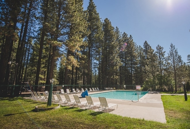 Chairs arrayed around a turquoise swimming pool