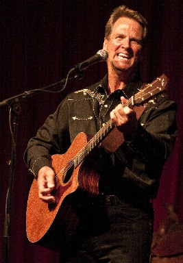 Singer strumming a guitar