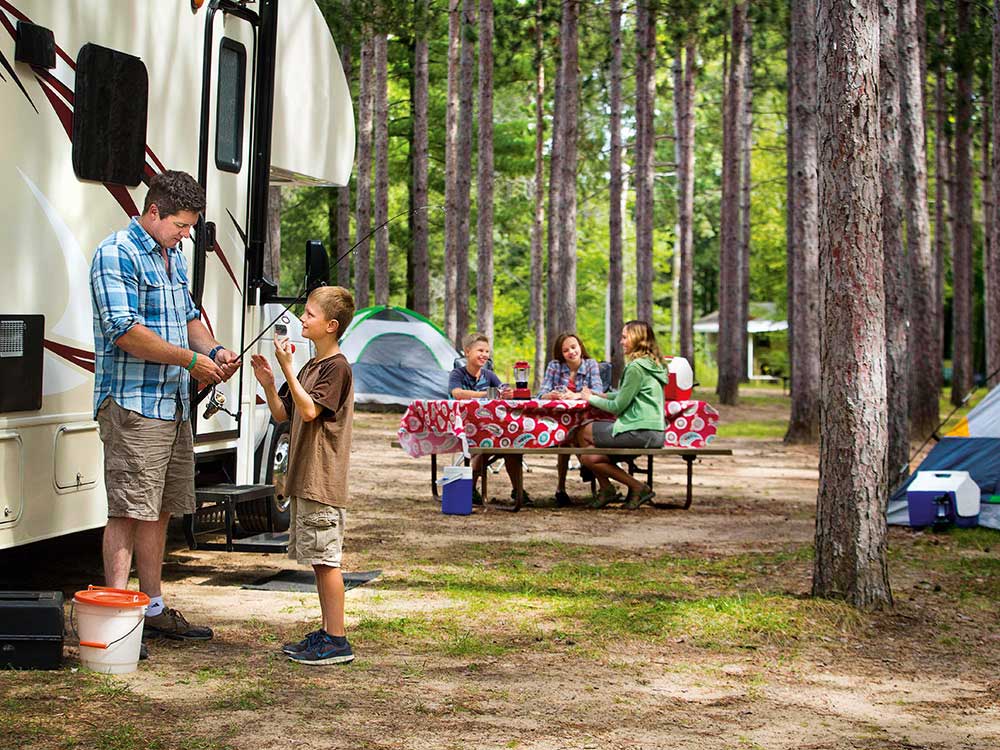 A family camping in thick woods. 