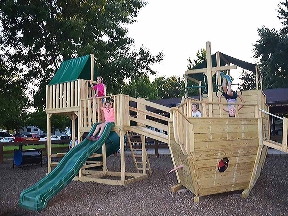 an award-winning campground — Kids play on a boat in a playground.