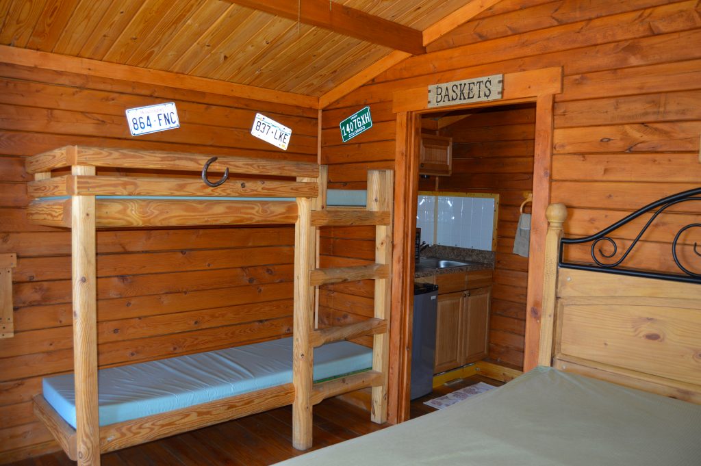 A bunk bed in a wooden cabin.