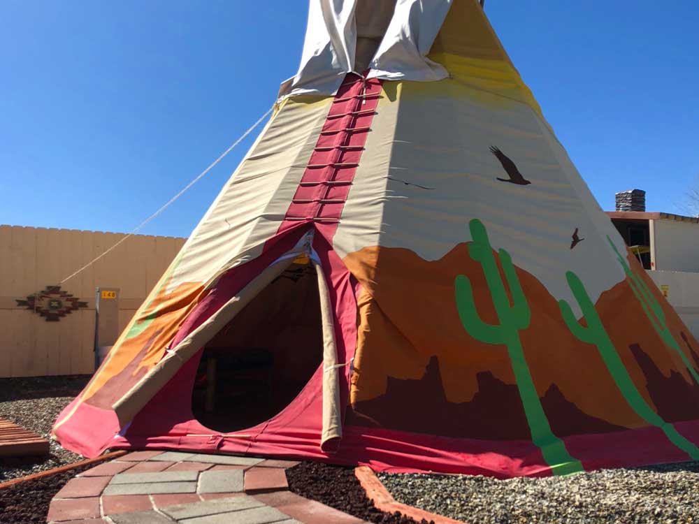 A colorful tepee with cactus designs.