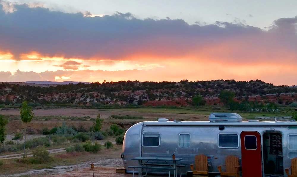 A silver trailer at sunset.