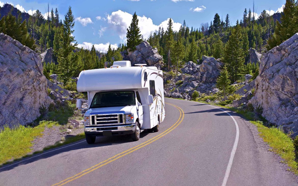RV taking the curve of a mountain road.