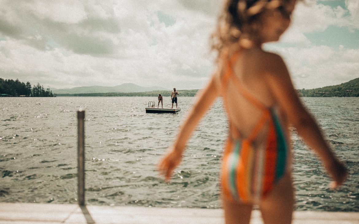 Young girl in bathing suit on dock at Lake Winnipeasukee