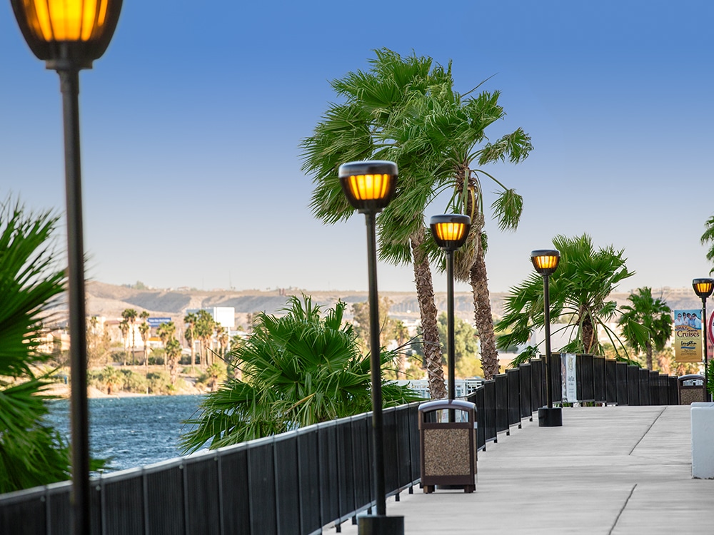 Streetlights line a riverside walkway.