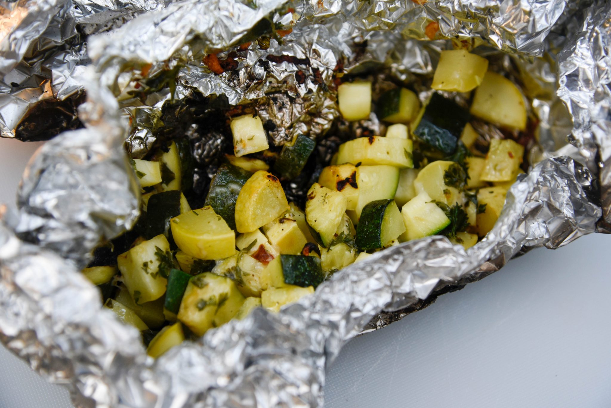 Farm to Fire With Parmesan Zuchini Campfire Foil Packets | Good Sam