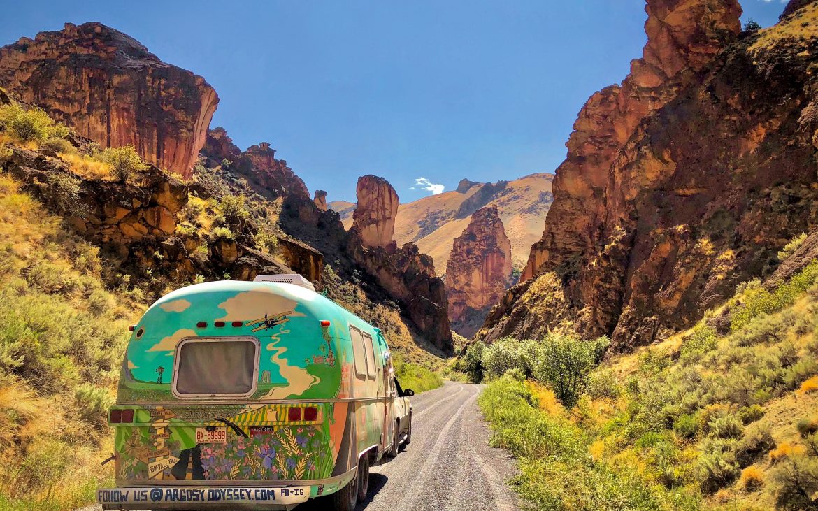 Colorful trailer driving on road through Leslie Gulch Wilderness Study Area