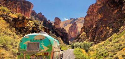 Colorful trailer driving on road through Leslie Gulch Wilderness Study Area