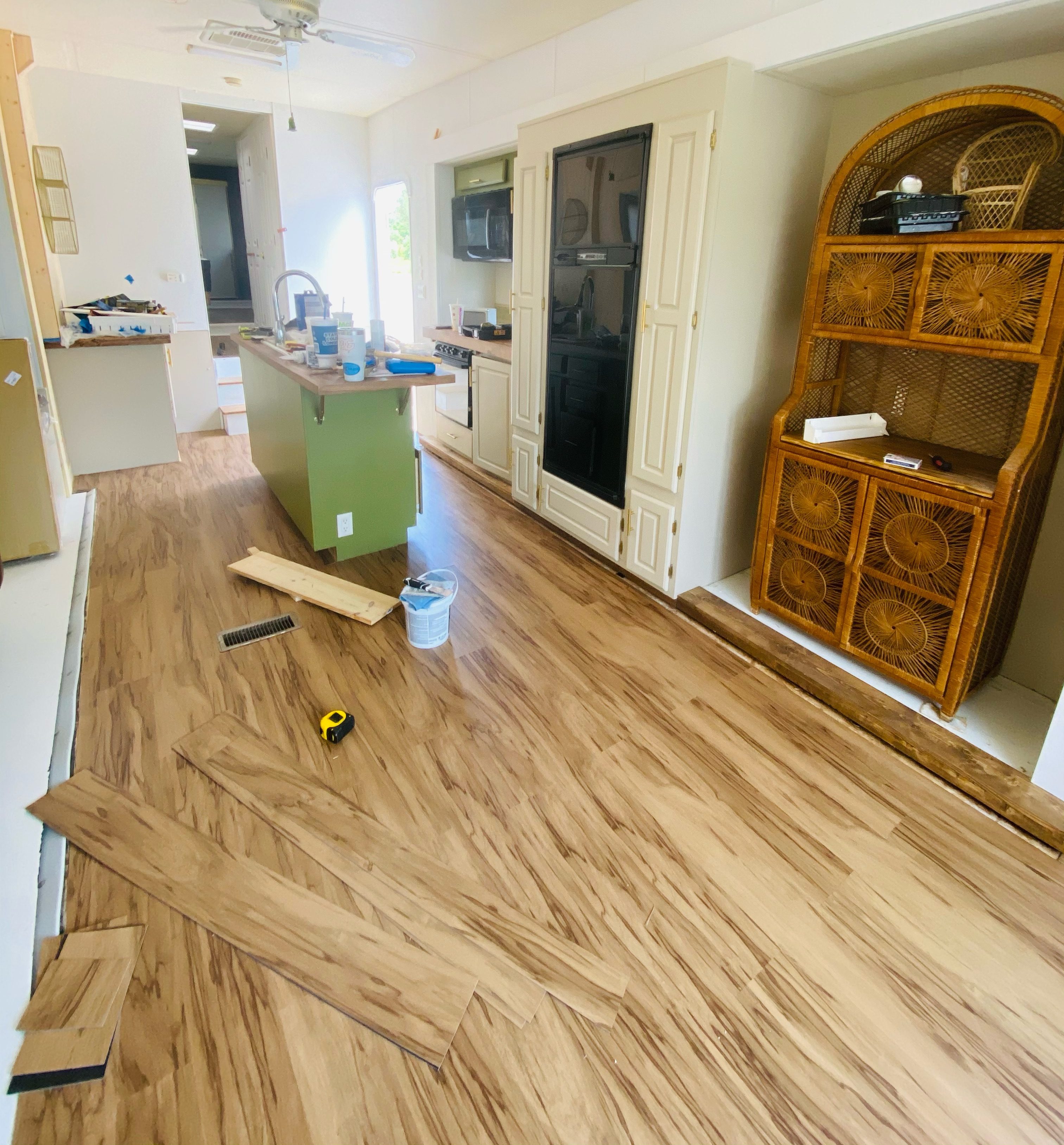 New plank flooring around a kitchen island.