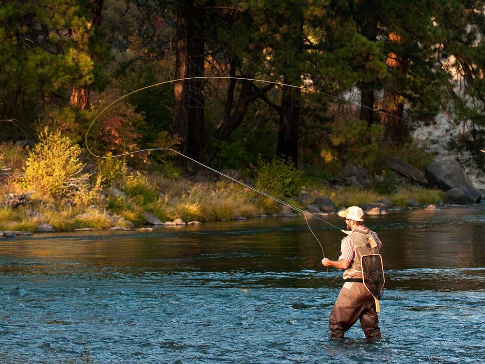 Man casting a long fishing line.